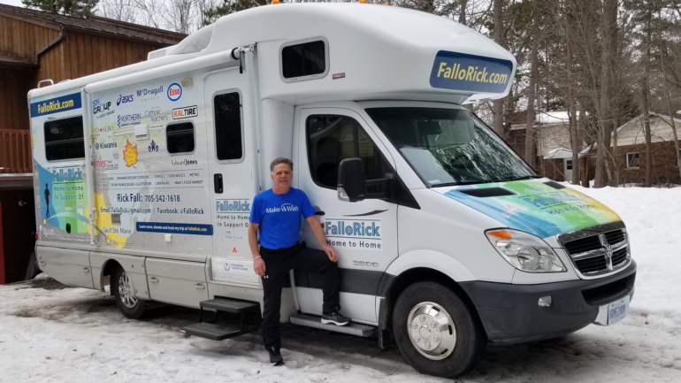Rick Fall standing beside his support vehicle which will be his home away from home during his journey.