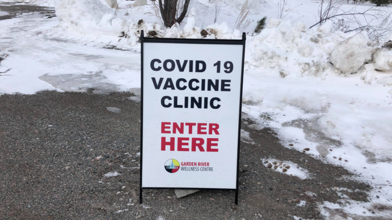 COVID-19 sign that sits outside of the recreation centre to advise individuals where th clinic is taking place.