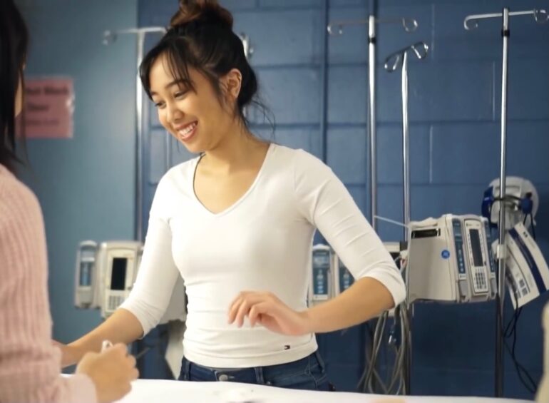 Fourth-year nursing student Aya Franco helps first-year students practice clinical skills in a simulation lab at Queen's University. Franco is set to graduate in Apr. 2021 as a Registered Nurse, exactly what Humber plans to begin certifying by Fall 2021. Courtesy: Aya Franco.
