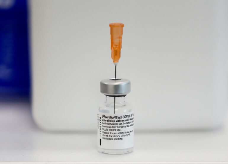 A vial of the Pfizer-BioNTech coronavirus disease (COVID-19) vaccine is seen on a table.