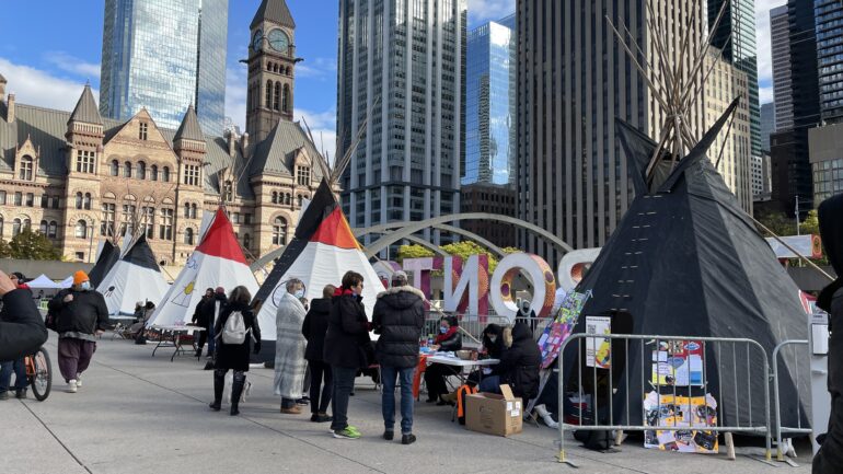 Dressing-up Nathan Philips Square, the Tipis, painted with allusive representations of Indigenous communities, surrounded the main- stage during the fourth Indigenous Gathering in downtown Toronto.