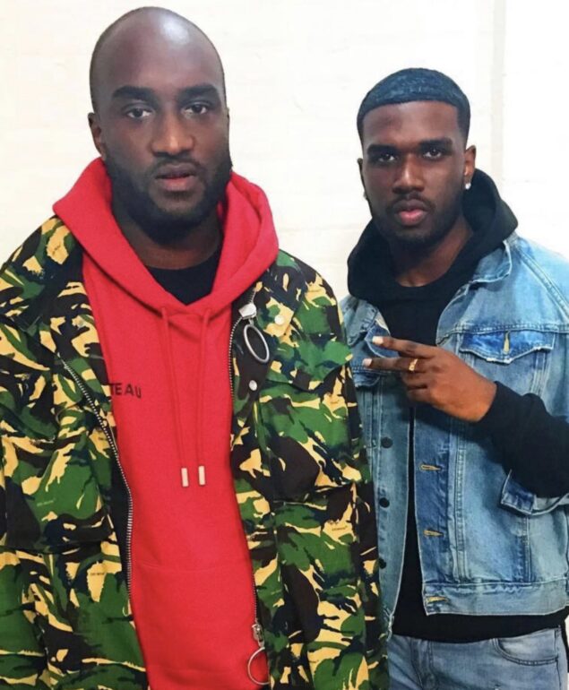 Aston Singh posing in a picture with Virgil Abloh at a fashion show.