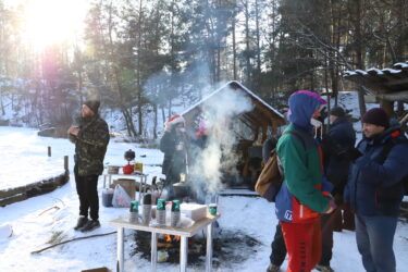 People gathering to get a cup of mulled wine after Epiphany dipping on the Canyon in Korostyshiv, Ukraine on Jan. 19, 2021. .