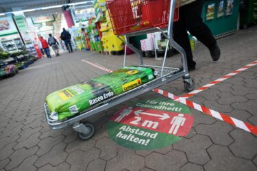 A customer buys gardening soil at a hardware store March 1 during the pandemic, as stores are allowed to re-open in Munich. Gardening has boomed since COVID-19 forced the lockdown of communities.
