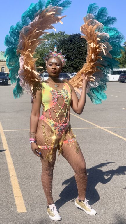 Akayla Maitland wearing a frontline costume from her band at Exhibition Place at the Toronto Caribbean festival in 2019.