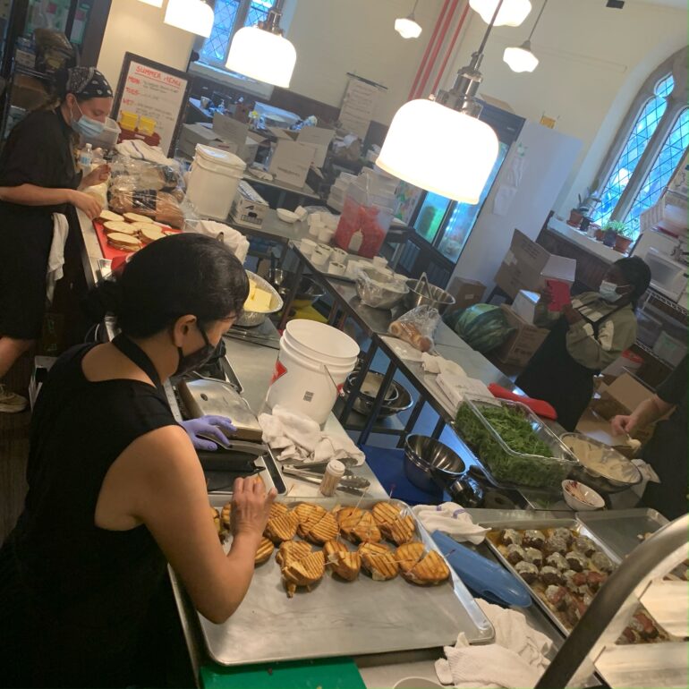 Unity Kitchen volunteers preparing food for vulnerable populations in Toronto.