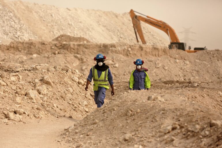 Workers walk back to the Al-Wakra Stadium worksite being built for the 2022 World Cup, in Doha, Qatar. Human Rights Watch released on Dec. 22, 2015, a set of guidelines it says construction companies working in the oil-rich Gulf Arab states should follow to ensure basic rights for migrant workers. Qatar in particular has come under intensified scrutiny over its labour practices since winning the rights to host the 2022 World Cup.