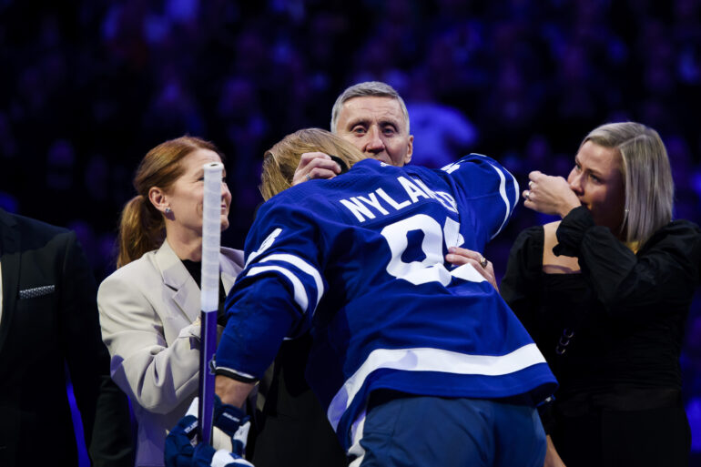 Former Toronto Maple Leafs defenceman Borje Salming, joined by his wife Pia Salming and family members, is greeted by Toronto Maple Leafs right wing William Nylander while being honoured during a pregame ceremony before NHL hockey action between the Toronto Maple Leafs and the Vancouver Canucks in Toronto on Nov. 12, 2022.