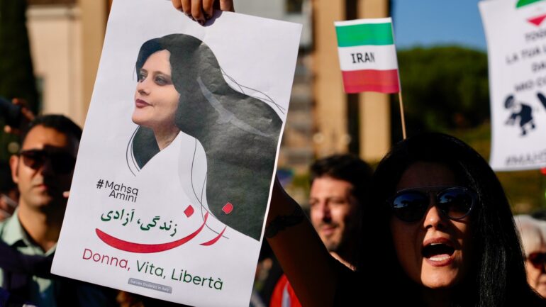 People staged a protest against the death of Mahsa Amini, a woman who died while in police custody in Iran, during a rally in central Rome on Oct. 29, 2022. Amini, 22, was held by Iran's morality police for allegedly wearing the mandatory Islamic headscarf too loosely.