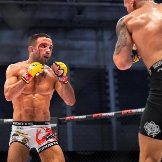 Aaron Aby with a bloody eye trading blows during his Cage Warriors bout. Aby returned to Cage Warriors just eight months after he was cleared of cancer.
