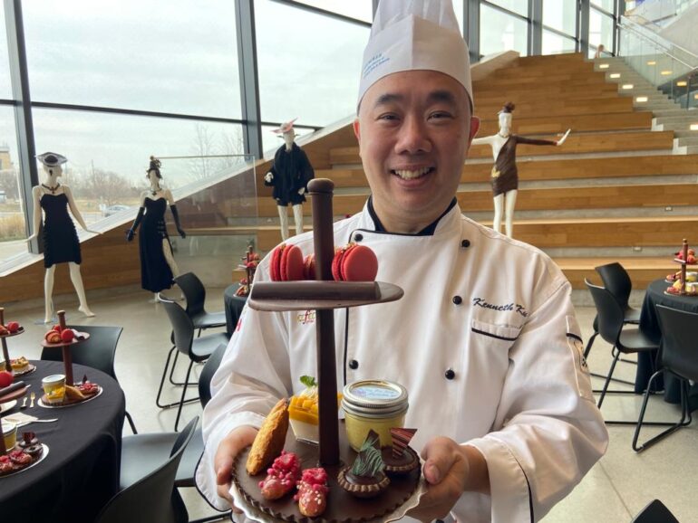 Kenneth Ku, a chef and instructor in the baking and pastry arts program at Humber College, holds up a platter of different sweets all incorporating chocolate.