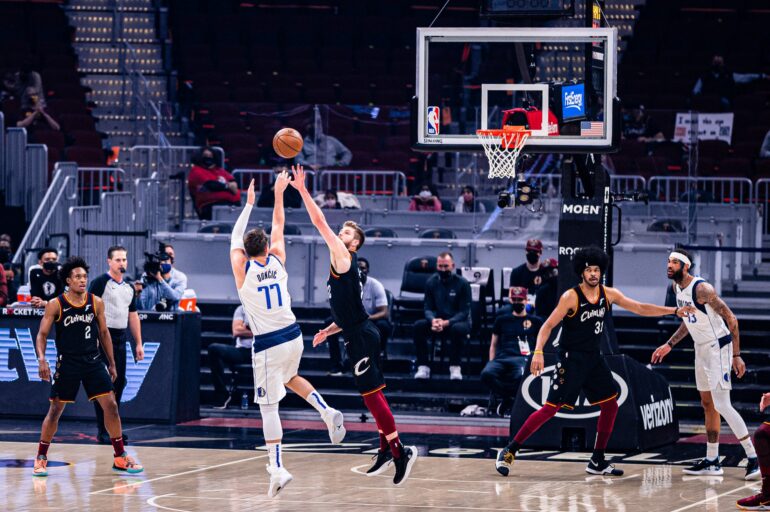 Luka Doncic shoots a jumper over the Cleveland Cavaliers' Dean Wade. Doncic has continued to impress from three point range and remains an MVP contender this season.