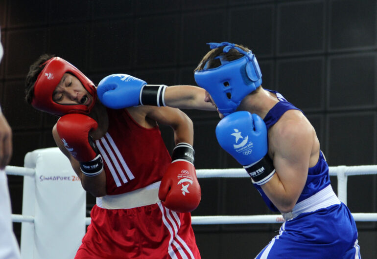 Dashdorj Anand (L) of Mongolia battles with Chval Jakub of Czech Republic during the Feather 57 kg boxing Place 5 and 6 match in Singapore Youth Olympic Games August 23, 2010.