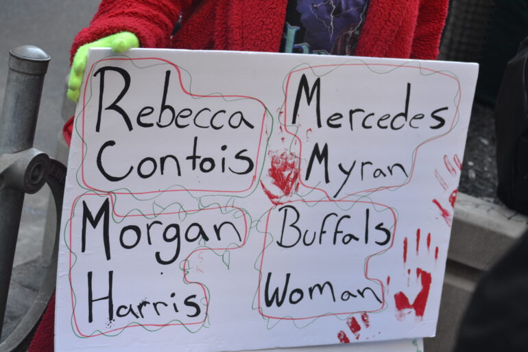 A sign displaying the names of four murdered indigenous women.