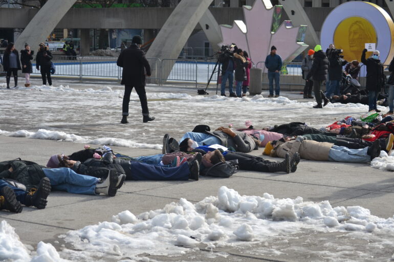 Several protestors lay on the floor outside