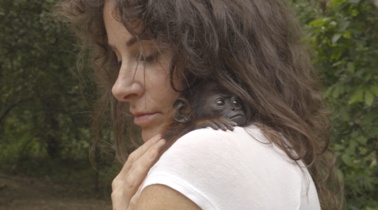 Ontarian Jana Bell with a recently born monkey at the Peruvian Amazon forest. Horizontal.