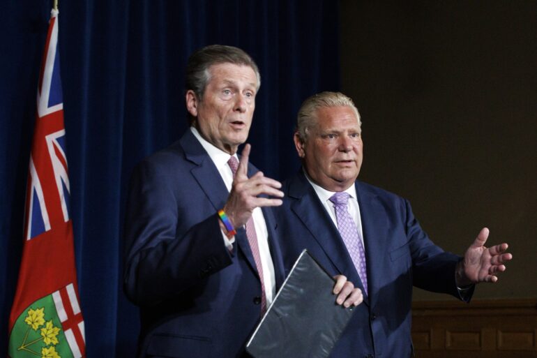 Toronto mayor John Tory, left, speaks alongside Ontario premier Doug Ford during a joint press conference inside Queen’s Park
