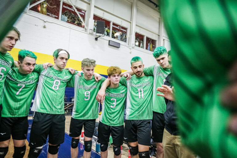Players of the Sherbrooke Volontaires men's volleyball team huddle during their CCAA championship game against the VIU Mariners on March 8, 2023.