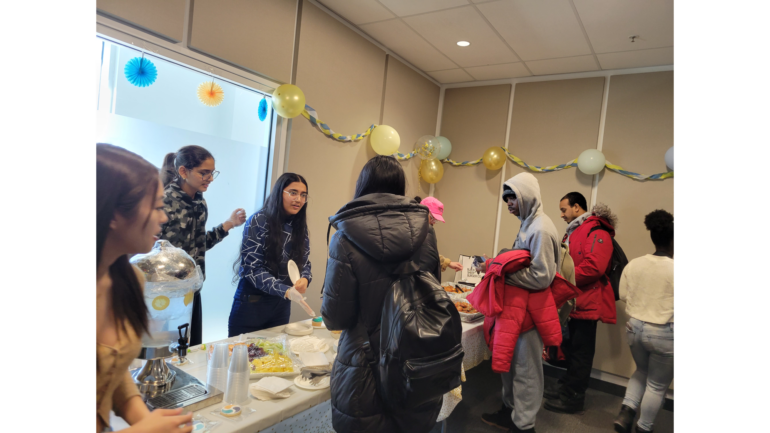 Volunteers serving food at the Spirituality and Wellness Centre grand opening today at North Campus.