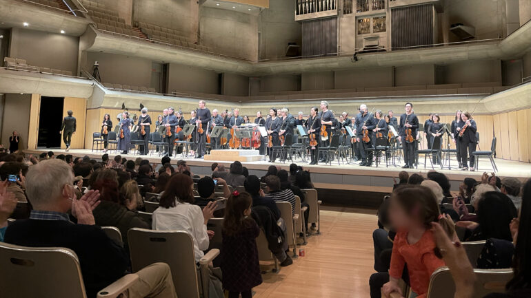The end of the relaxed performance that took place at the Roy Thomson Hall on March 25, 2023. The TSO stands while the audience claps and conductor Gustavo Gimeno goes out searching for cellist Jean-Guihen Queyras to thank the audience.