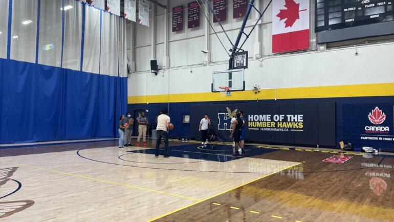 Harkaran Sandhu, shooting a basketball at the free throw line in Humber College North Campus gym.