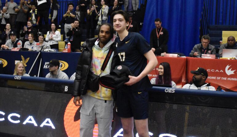 Humber men's volleyball middle blocker Michael McAlpine is awarded as the player of the match after his team defeated the Sherbrooke Volontaires on March 9, 2023.