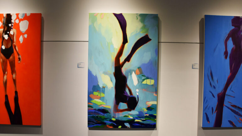 Paintings of figures diving in the ocean.