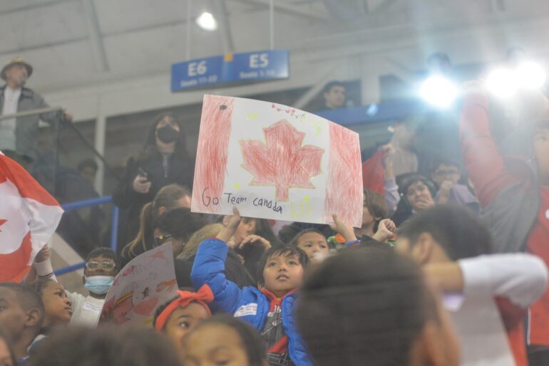 A kid showed a handmade sign written "Go Team Canada" in the 2023 Canadian National Blind Hockey Tournament in Mattamy Athletic Centre.
