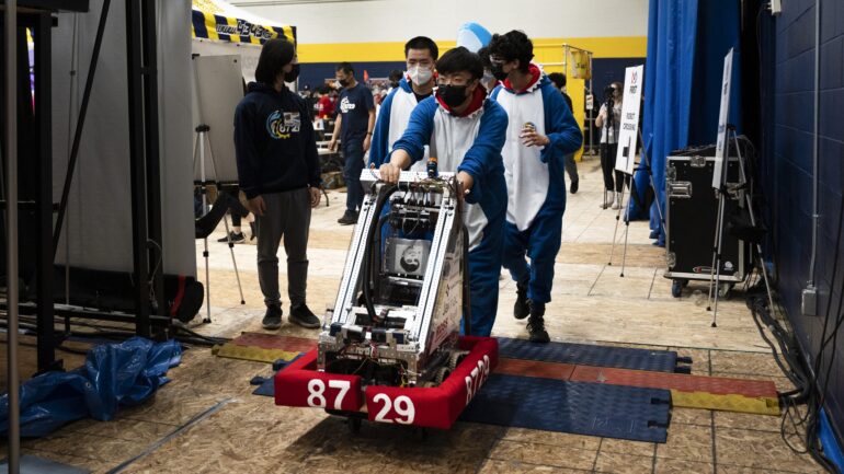 Sparkling H20 Ottawa robotics team cart their robot to the pit for their next match at the annual Humber College FIRST robotics competition.