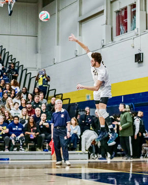 Humber veteran setter Jake Gomes serves the ball toward the Camosun Chargers at the CCAA championship match on March 11, 2023.