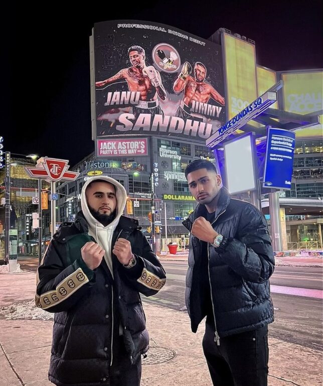 Jimmy and Janu Sandhu posing infront of their billboard in downtown Toronto. This was the promotion for their professional boxing debuts in early 2022.