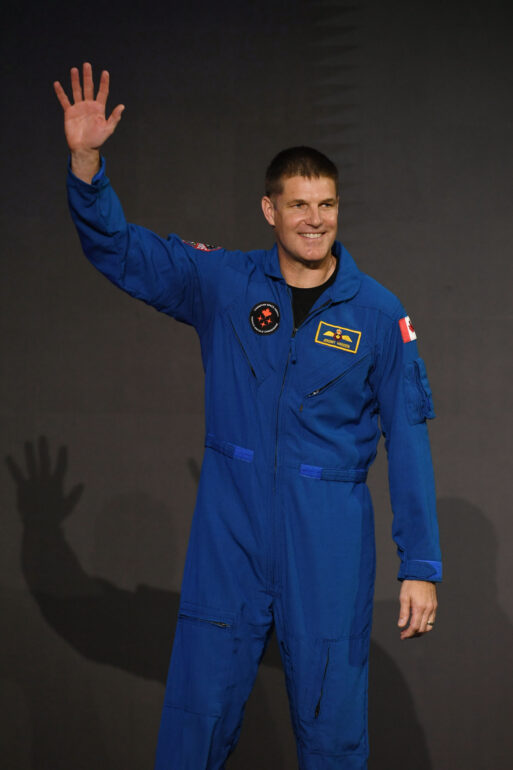 Canadian astronaut Jeremy Hansen waves his hand at the announcement of the crew on the Artemis II mission on April 3, 2023.