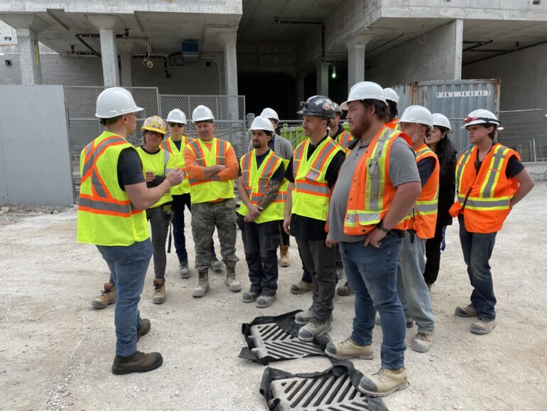 Brad Bradford talked to workers in a construction site after his announcement on Main Street on May 19, 2023.