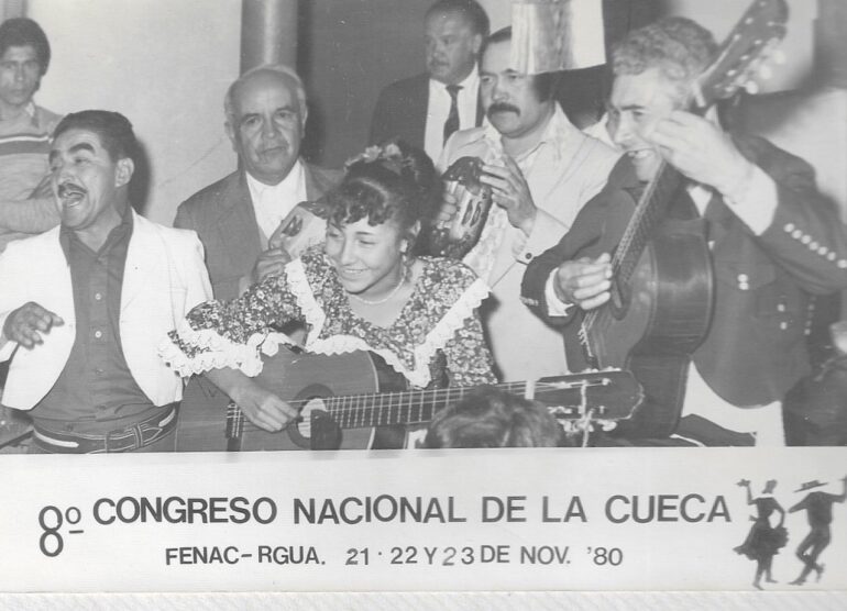 Pedro Riquelme (seen holding the tambourine in the middle right) is pictured with other performers at the 8th National Congress of Cueca in Chile.