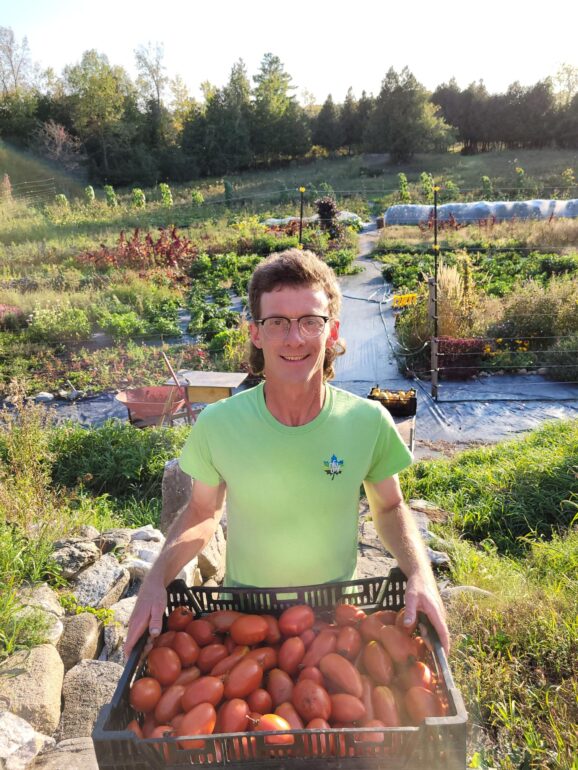 Max Hansgen, president of the Ontario National Farmers Union, collects tomatoes from his Farm in Lanark, Ont.