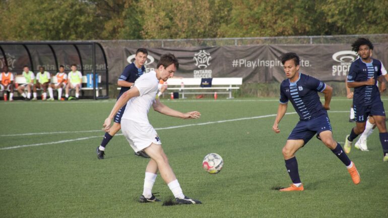 Soccer player taking a touch in the attacking 18-yard box