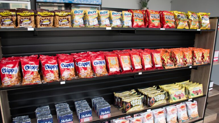 A shelf with chips and snacks.