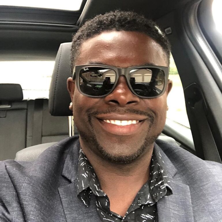 An image of Leon Brown wearing sunglasses in a vehicle.