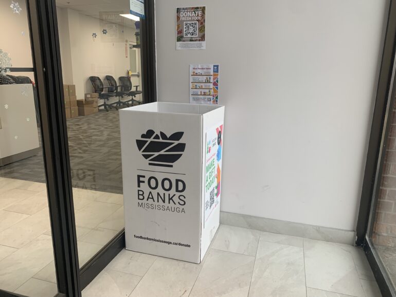 A white donation box with "Food Banks Mississauga" written on it.