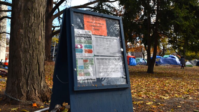 Toronto Homeless Union set up a community board advertising essential services at Allan Gardens.