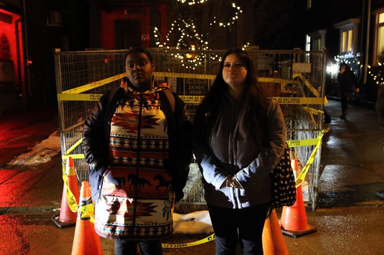 Ariyha Syvret (L) and Rain King pose after the Indigenous vigil at eh backdrop of the site where the 'ancient' remains were found.