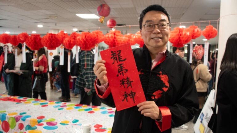 Andy Wong holding a sign.