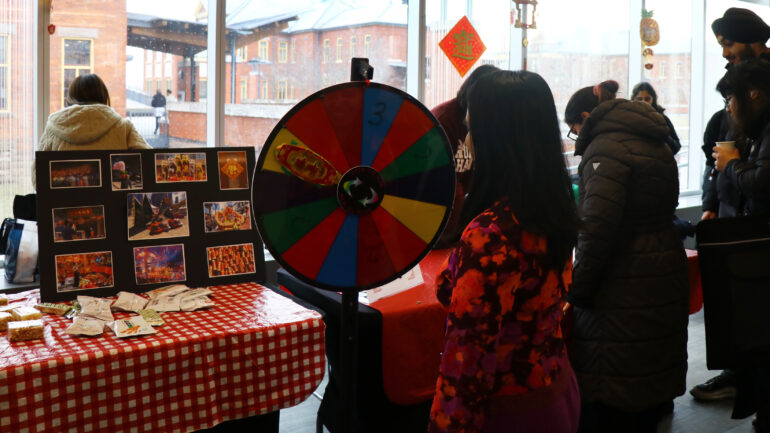 Samantha Maquera, president of the Filipino Association Club at Humber College, spins the wheel at the Lunar New Year event at Humber's Lakeshore campus on Feb. 8.