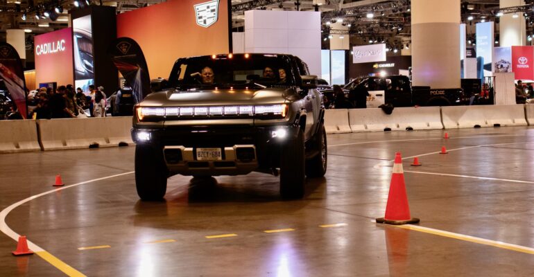 An electric GMC Hummer rounds a corner of the indoor track during a test drive at the Toronto AutoShow. It wraps up on Feb. 25.