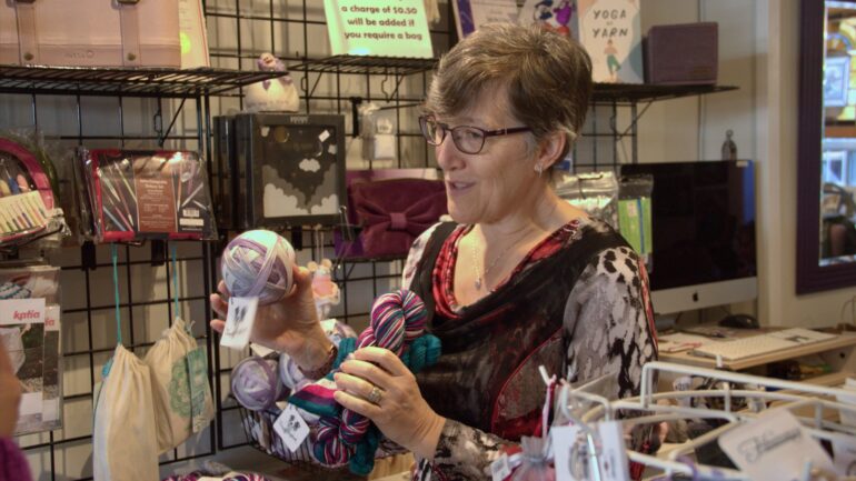 Treena Evans showed items at her store. She launched Project Warmth from her Lakeshore Boulevard West store to help people stay warm by offering free knitted mitts, hats and scarves.