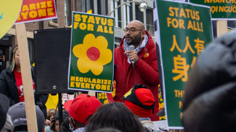 Syed Hussan spoke to the crowd as they occupied the intersection of Bloor and Spadina outside Deputy Prime Minister Chrystia Freeland's office.
