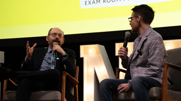 (From left) American physician and NYT bestselling author Michael Greger sits with The Exam Room host Chuck Carroll in a live podcast recording for the Planted Expo on March 23.