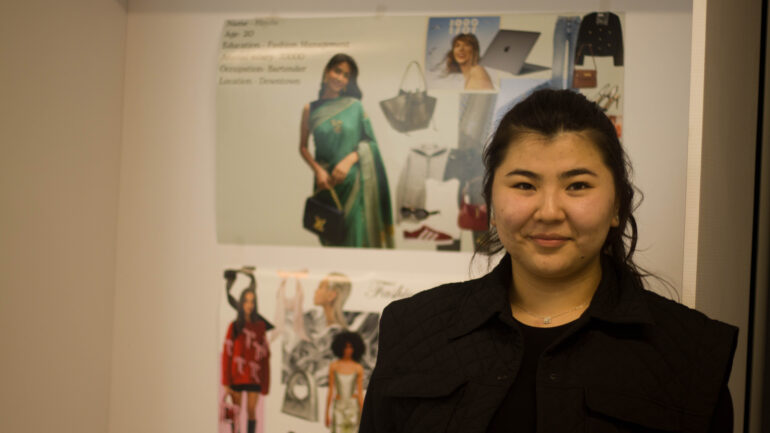 A fashion management student, Elina, posing with her mood board.
Picture Credit: Niharika Nayak