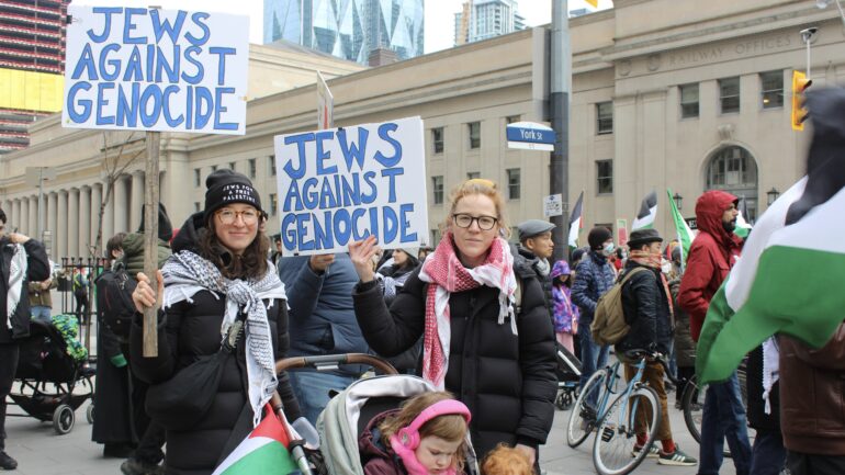 Sarah Ovens, a Jewish woman, with her sister and two children at the Palestinian support rally on Saturday at Bay Street.