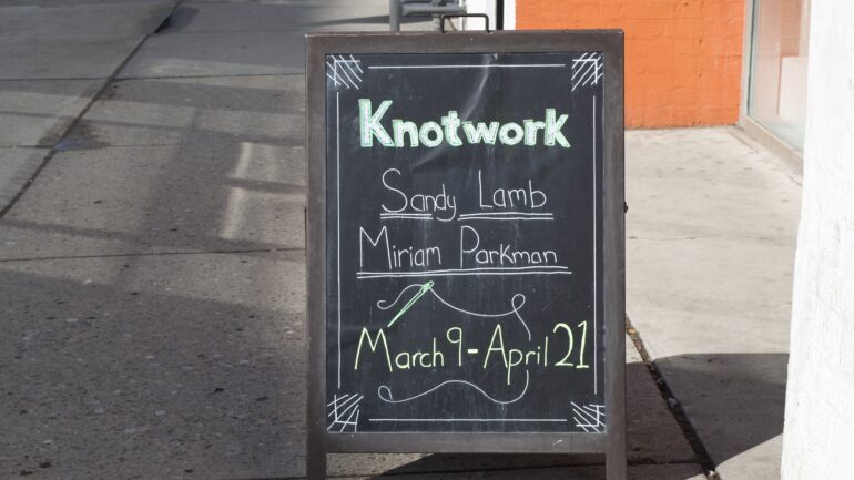 A sign for Knotwork outside Craft Ontario store.